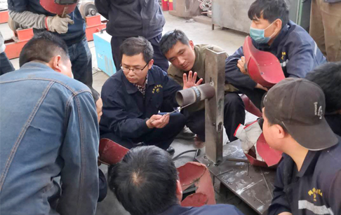 Factory workers receive training of welding technology for high quality machine